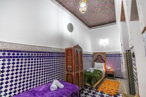 Postel nebo postele na pokoji v ubytování Dar Amazigh