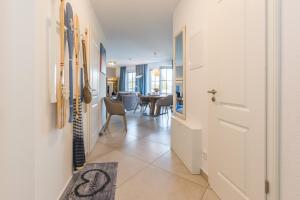 a hallway with a door and a dining room at Victoria Luna Penthouse No 10 Strandstrstr48 in Zingst