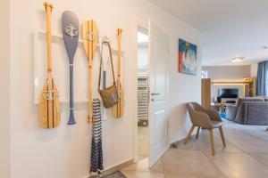 a room with skis and snowboards hanging on a wall at Victoria Luna Penthouse No 10 Strandstrstr48 in Zingst +15 photos