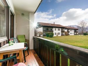 a balcony with a view of a house at Chiemgau Comfort E2 Ferienwohnanlage Oberaudorf mit Hallenbad und Sauna in Oberaudorf