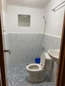 a bathroom with a toilet and a sink at Kahayag Homestay in Burgos