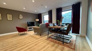 a living room with a table and chairs and a desk at Superb Apt at the Marina in Portishead