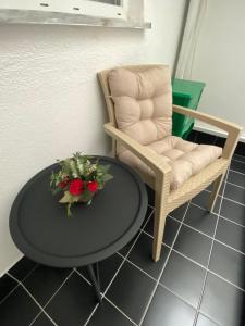 a chair and a table with a vase of flowers at Huzur Apart Hotel in Istanbul
