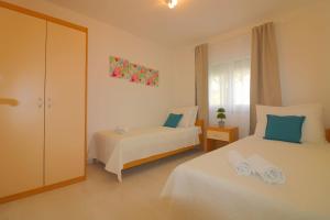 a bedroom with two beds and a window at Melisa 5 in Poreč