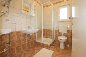 a bathroom with a toilet and a sink and a shower at Melisa 5 in Poreč