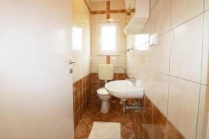 a bathroom with a white sink and a toilet at Melisa 5 in Poreč