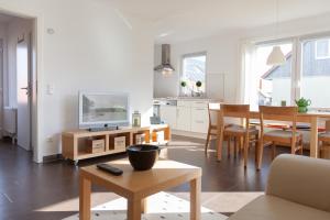 a living room with a television and a dining room at Ferienhaus Innenförde in Holnishof