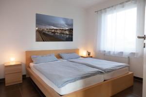 a bedroom with a bed with a painting on the wall at Ferienhaus Innenförde in Holnishof