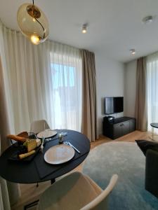 a living room with a black table and chairs at Eck am Meer 2 in Eckernförde
