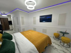 a bedroom with a bed and a tv on the wall at studio lipscani Old Town Center in Bucharest