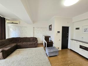 a living room with a couch and a table at Center, Ismail str.apartment, 1 bedroom and living in Chişinău