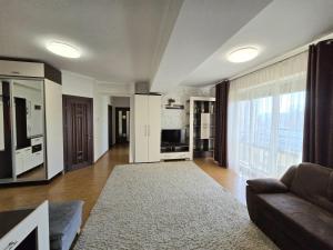 a living room with a couch and a television at Center, Ismail str.apartment, 1 bedroom and living in Chişinău