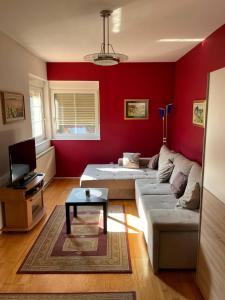 a living room with a couch and a tv at Green Home in Krapinske Toplice