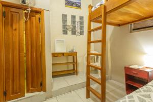 a bedroom with a bunk bed with a ladder and a desk at Casa #344 - Habitación 2 - Twin & Bunk Bed - NO AC in Puerto Ayora