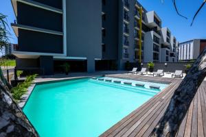 a swimming pool in front of a building at 226 Millennial Umhlanga in Durban