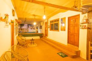 a room with a bar with chairs and a door at Casa #344 - Habitación 3 - Full-Twin Bed - AIR CONDITIONING in Puerto Ayora