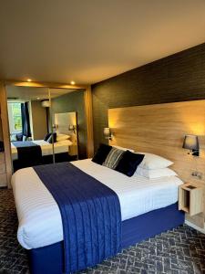 a hotel room with a large bed and a mirror at No5 Durley Road in Bournemouth +24 photos