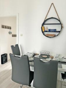 a dining room with a table and chairs and a mirror at See-Hase in Grömitz +16 photos