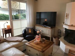 a living room with a couch and a tv at Godeke Michels Ferienwohnung 21 Seestr5b in Groß Kirr