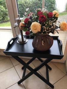 a black table with a vase of flowers on it at Godeke Michels Ferienwohnung 21 Seestr5b in Groß Kirr