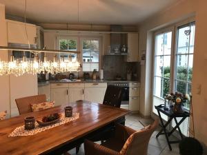a kitchen with a large wooden table and chairs at Godeke Michels Ferienwohnung 21 Seestr5b in Groß Kirr +14 photos