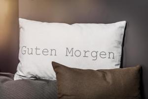 a pillow with the words eaten morgan written on it at Zur guten Quelle in Cologne