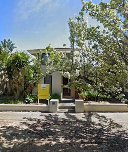 a house with a flowering tree in front of it at Premium Snooze Queen Bed Petite Room in Caroline Springs