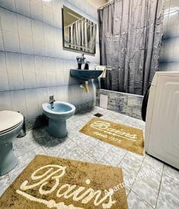 a bathroom with a sink and a toilet and a bidet at Apartman Baljak in Livno