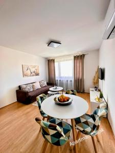 a living room with a table and chairs at Apartman Baljak in Livno