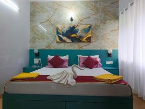 a bedroom with a bed with a swan on it at Enjoy at Your Own Luxurious Home with LPG Pool Net in Arpora +32 photos