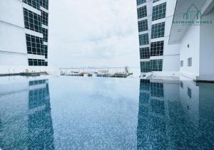 a swimming pool in the middle of two tall buildings at Maritime Sea View Duplex in George Town