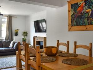 a living room with a wooden table and chairs at The Hideaway - Spacious 3 Bedroom Apartment in Truro