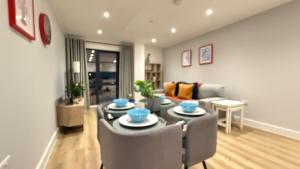 a living room with a table and chairs at Bright and spacious Apartment in Portishead