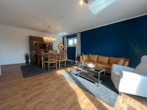 a living room with a couch and a table at Wohnglück Bad Zwischenahn in Bad Zwischenahn