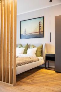 a couch in a room with a bridge painting on the wall at NEW - NORA Stays Studio - Messe - Airport in Dresden