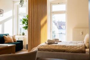 a bedroom with a bed and a window at NEW - NORA Stays Studio - Messe - Airport in Dresden