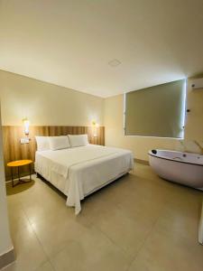Postel nebo postele na pokoji v ubytování Hotel Oscar Gold Janaúba