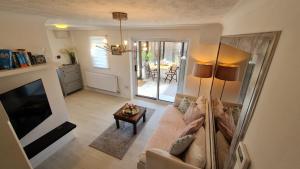 a living room with a couch and a television at Lomond Gardens Place in Addington
