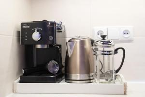 a coffee maker on a shelf with a coffee pot at Hygge Oasis for family with free parking and wi fi in Vilnius