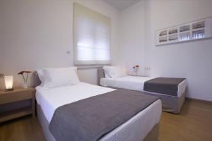 Cama o camas de una habitación en Ikia Luxury Homes