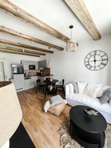 a living room with a white couch and a table at Bergzeit by Alpenidyll Apartments in Aich