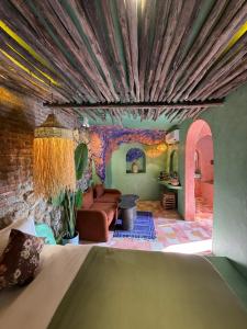 a living room with a bed and a couch at Casa Amina in Chefchaouene
