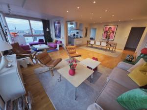 a living room with a couch and a table at ArticVieW Tromsø city centre in Tromsø