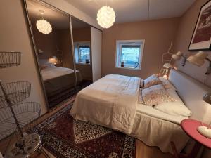 a bedroom with a bed and a large mirror at ArticVieW Tromsø city centre in Tromsø