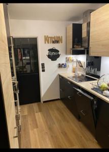 a kitchen with a door leading to a kitchenasteryasteryasteryasteryasteryasteryastery at Liberté Room Chambre privée en colocation conviviale ! in Nanterre +3 photos
