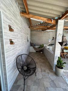 a patio with a bench and a hammock in a room at Rancho Lopes - Casa com piscina e churrasqueira, Iguape-SP in Iguape +25 photos