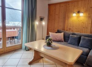 a living room with a couch and a table at Philipp -701- in Mittenwald