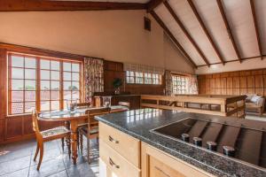 a large kitchen with a table and a dining room at Sandown Estate Apartment in Johannesburg