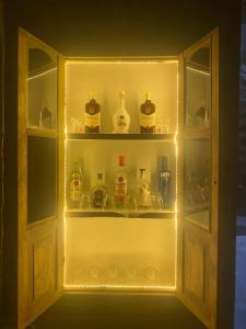 a cabinet filled with lots of bottles of alcohol at Hornbill Soirees Homestay - Aros, North of Goa in Sawantwadi