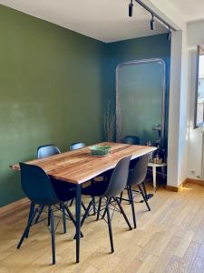 a dining room with a wooden table and chairs at Apartment in Montmartre in Paris